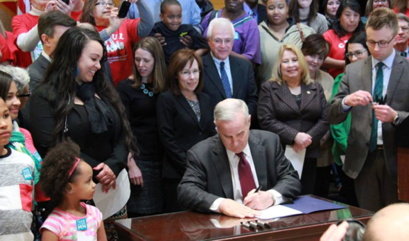 Governor Dayton signs a bill raising the minimum wage in 2014.