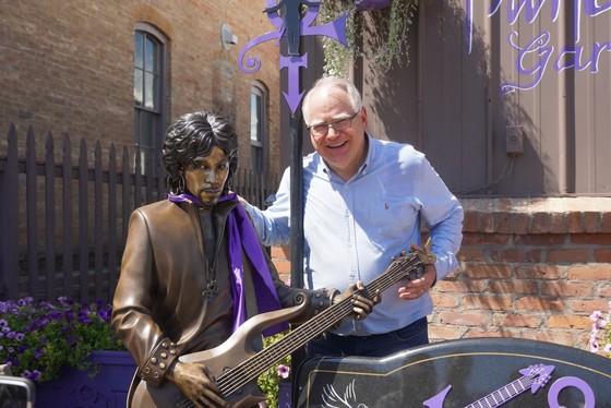 Governor Walz stands by Prince statue in Henderson, Minnesota 