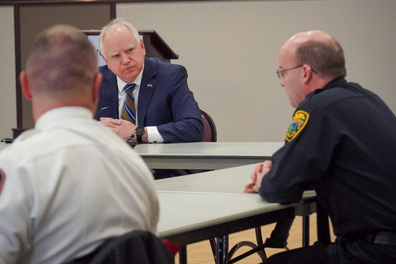 Governor Walz listens to two first responders about the challenges they face with public safety in the city of Brooklyn Park.