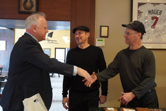 Governor Walz smiles as he shakes hands with the owners of Kramarczuk Deli - a Ukrainian-owned business.