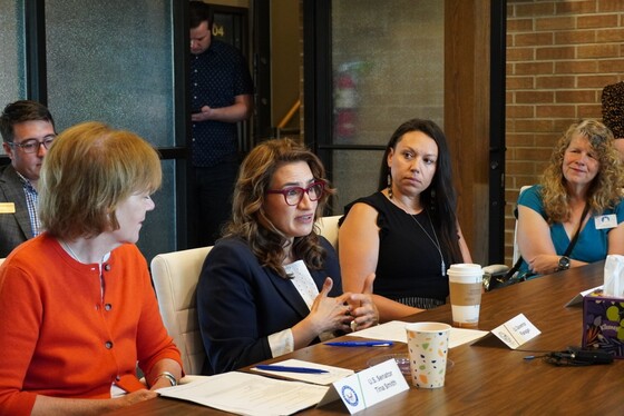 Lieutenant Governor Flanagan and U.S. Senator Smith talk to Red River Women's Clinic staff.