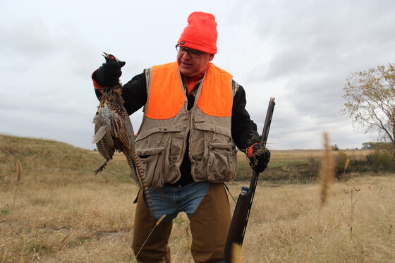 Governor Walz holds a pheasant