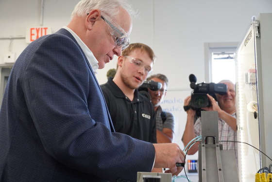 Governor Walz works with manufacturing equipment 