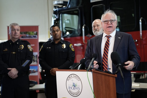 Governor Walz speaks to press from a fire station. 