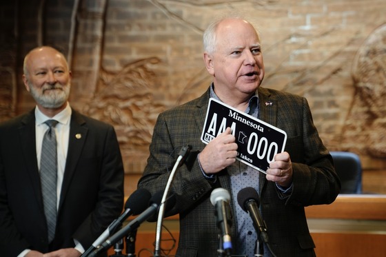 Governor Walz shows off Minnesota's new "blackout" license plate to press from White Bear Lake City Hall.