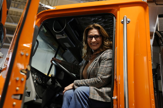 Lieutenant Governor Flanagan poses from the driver's seat of a MnDOT snowplow.