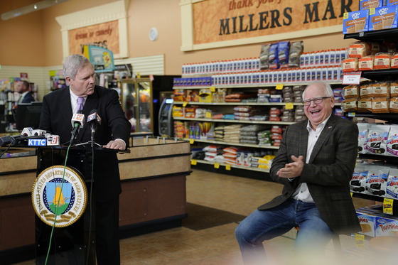 Secretary Vilsack cracks a joke to Governor Walz while speaking to press at Miller's Market