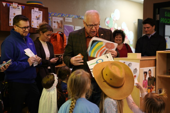 Students at a Head Start program hand Governor Walz their artwork before he highlights the Child Tax Credit
