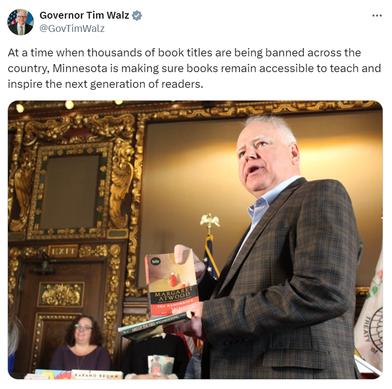 Governor Walz holds copies of banned books.