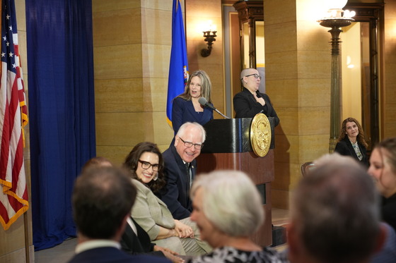 Governor Walz and Lieutenant Governor Flanagan smile to the crowd during the speeches of the new Supreme Court Justices