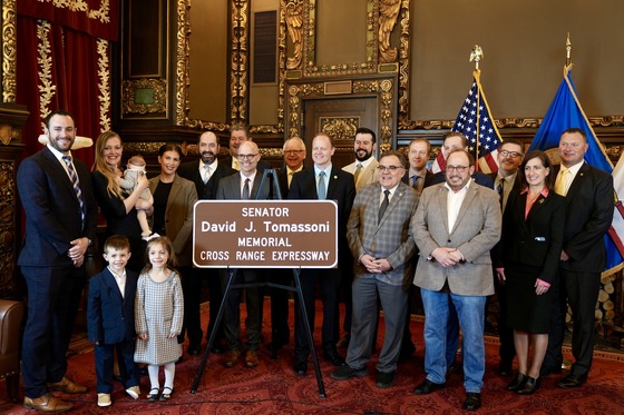 Governor Walz celebrates with legislators and members of the Tomasonni family