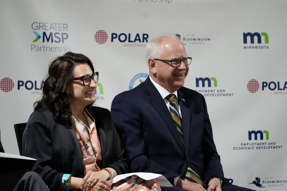 Governor Walz, Lt. Governor Flanagan smile from the stage