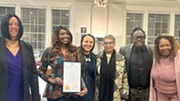 CEO and 1MN History Makers speakers holding the Black History Month Proclamation. 
