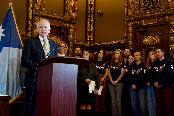 Governor Walz speaks to the press alongside parents from Annunciation Catholic School