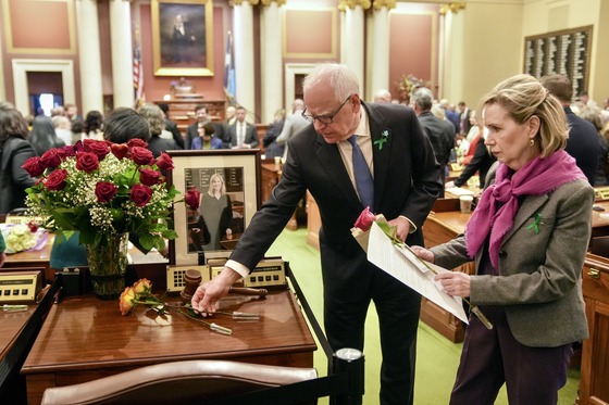 Governor Walz, First Lady Walz place flowers on the desk of Speaker Hortman