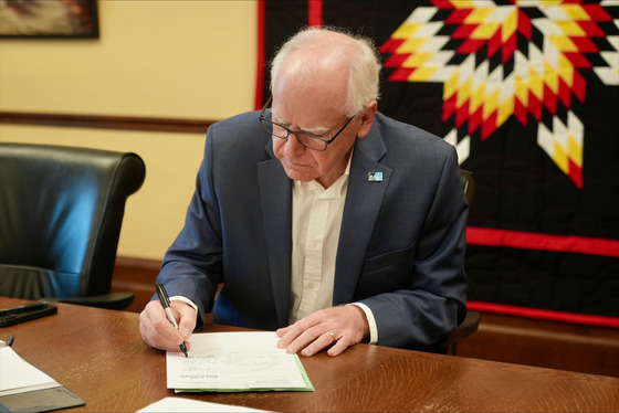 Governor Walz signs a bill into law at the State Capitol