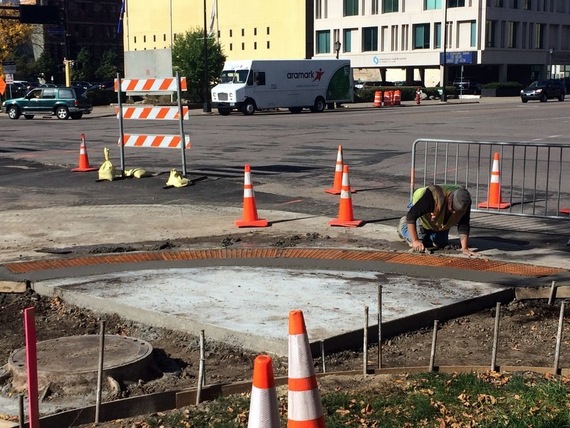 Installing a new pedestrian ramp at Hennepin and Washington