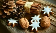 Photos of cinnamon sticks, pine cones, star cookies and whole walnuts in the shell
