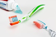 Photo of two toothbrushes with tube of toothpaste