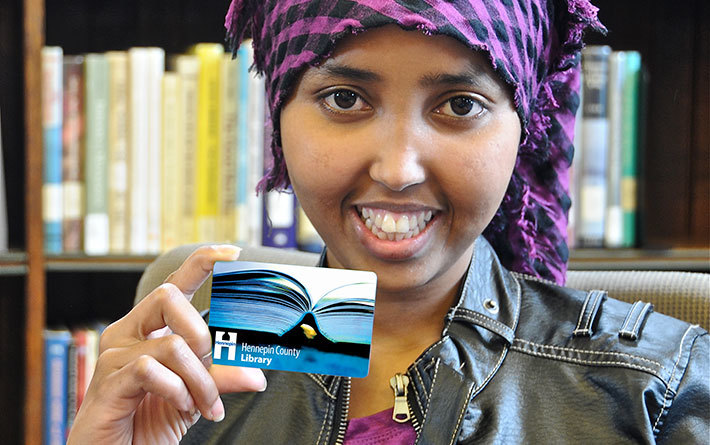 Person holding library card