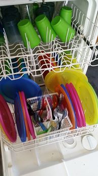 Dishwasher loaded with reusable party dishes