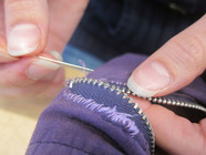 Sweater zipper being mended