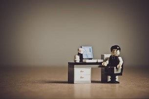 Image of Lego character sitting at a desk