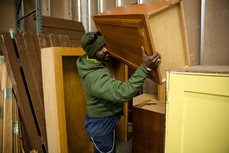 Man moving a cabinet