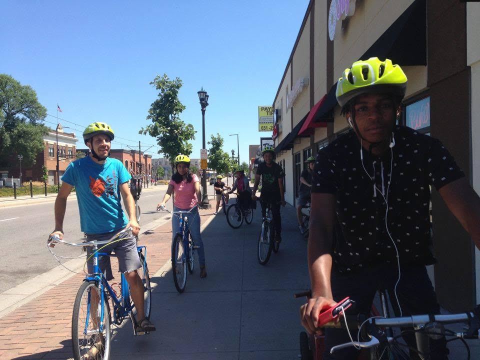 People on bikes wearing helmets learning to ride