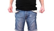 Photo of man pulling out the pockets of his jeans to show they're empty