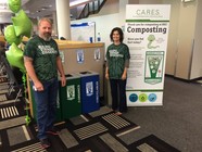 Organics recycling rollout with two green team members standing by bins at Boston Scientific