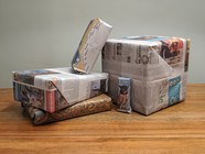 Assortment of boxes wrapped in newspaper