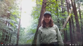 Bethany standing in a forest in uniform