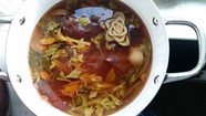 Pot with variety of vegetables cooking in liquid