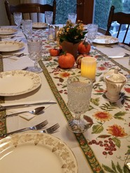 Table set for Thanksgiving with reusable dishware and fall decorations