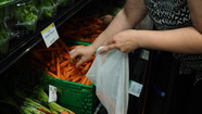 Using a reusable produce bag to purchase loose carrots