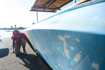 Inspector looking at boat for aquatic invasive species