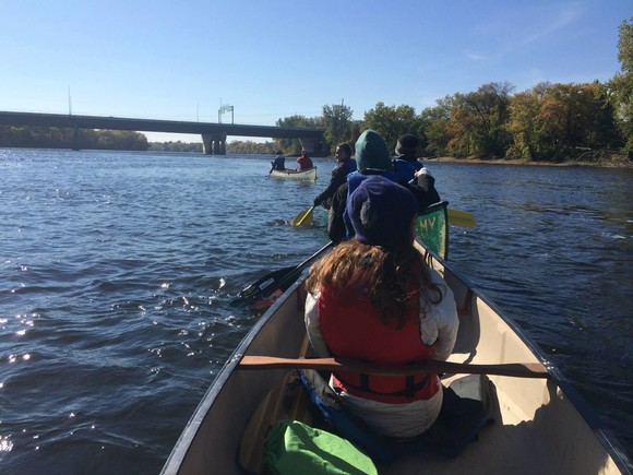 Youth paddling a canoe