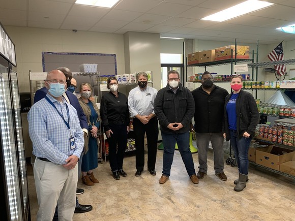 Commissioner LaTondresse and group of people pose at the market at Gatewood elementary