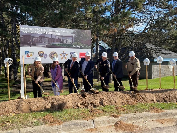 group of people with shovels and hard hats