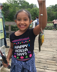 smiling girl holding a caught fish