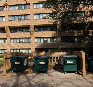recycling bins outside of an apartment building