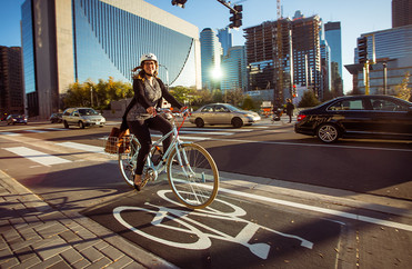 Woman riding bike on city street