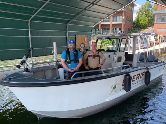 Commissioner LaTondresse on a boat with Hennepin County Sheriff's water patrol