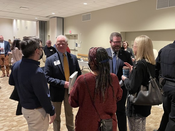 Commissioner LaTondresse standing near a group of people speaking