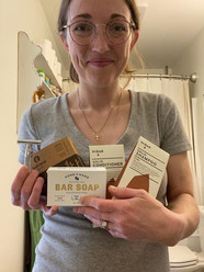 Woman holding bathroom supplies with less packaging waste