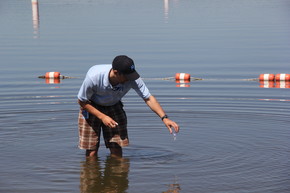 Hennepin County inspector taking a beach water sample