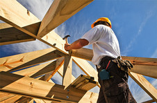 Construction worker working on house framing