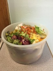 Salad in a plastic bowl