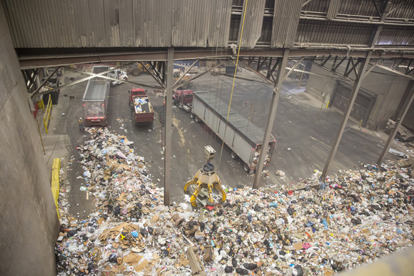 Tipping floor at HERC where garbage is dropped by trucks and picked up by a crane to be loaded into furnaces
